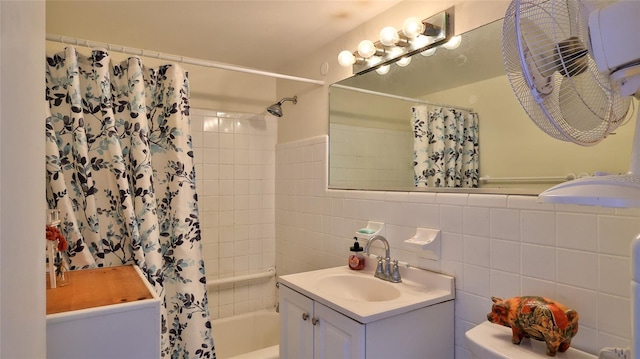 1233 N Atlantic Ave Unit 1020, Daytona Beach, FL 32118 - bathroom with vanity, shower / bath combo with shower curtain, and tile walls