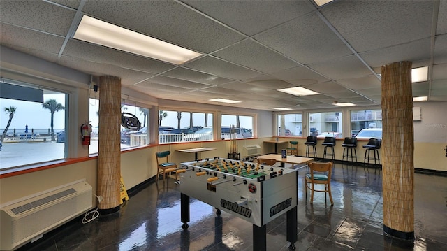 1233 N Atlantic Ave Unit 1020, Daytona Beach, FL 32118 - playroom featuring a drop ceiling and a wall mounted air conditioner