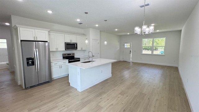 742 W Glenhaven Dr, Citrus Springs, FL 34434 - kitchen featuring appliances with stainless steel finishes, recessed lighting, white cabinetry, a kitchen island with sink, and light wood-style flooring