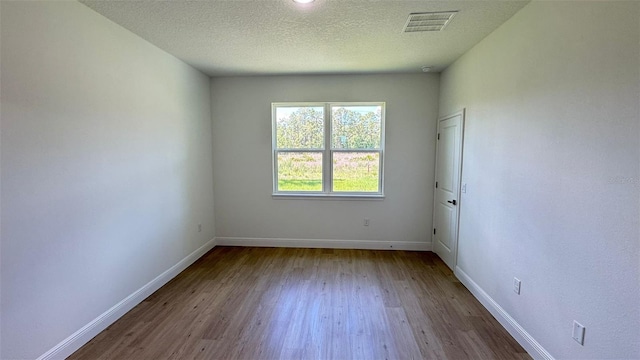 742 W Glenhaven Dr, Citrus Springs, FL 34434 - unfurnished room with wood finished floors and a textured ceiling