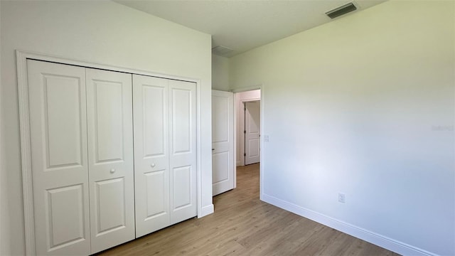 742 W Glenhaven Dr, Citrus Springs, FL 34434 - unfurnished bedroom with light wood-type flooring and a closet