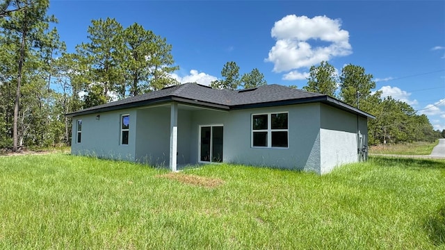 742 W Glenhaven Dr, Citrus Springs, FL 34434 - rear view of house with stucco siding and a yard