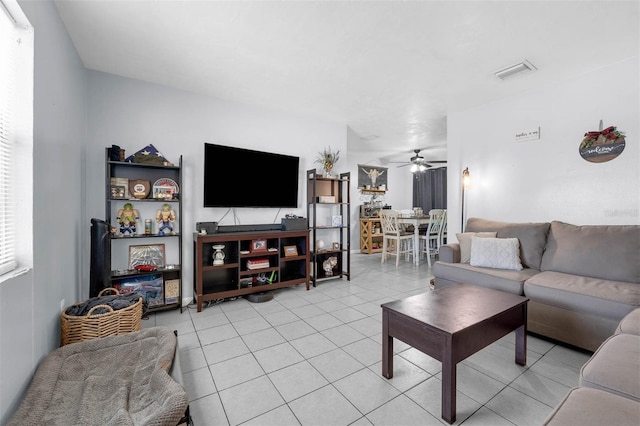 565 S Floyd Cir, Deltona, FL 32725 - living area with ceiling fan and light tile patterned flooring