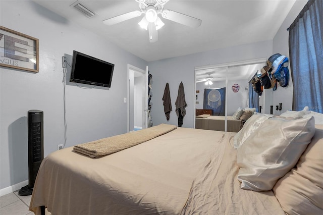 565 S Floyd Cir, Deltona, FL 32725 - bedroom with a closet, ceiling fan, and light tile patterned floors
