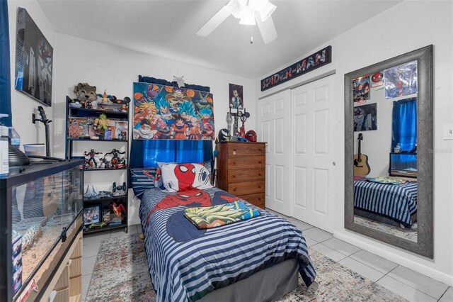 565 S Floyd Cir, Deltona, FL 32725 - bedroom with tile patterned floors, a closet, and a ceiling fan