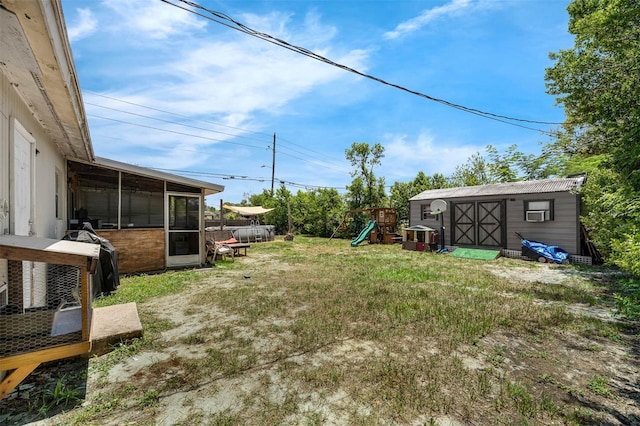 565 S Floyd Cir, Deltona, FL 32725 - view of green lawn featuring a sunroom, a playground, and a shed