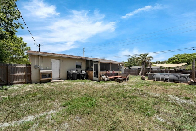565 S Floyd Cir, Deltona, FL 32725 - back of house featuring a sunroom and a fenced backyard