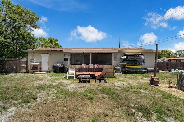 565 S Floyd Cir, Deltona, FL 32725 - rear view of house featuring a fenced backyard and a sunroom