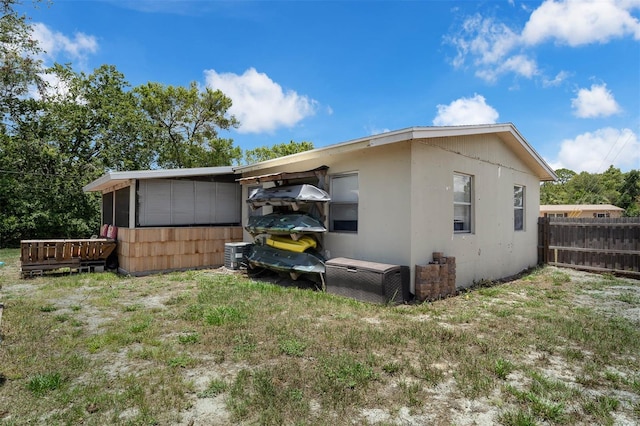 565 S Floyd Cir, Deltona, FL 32725 - back of house featuring a sunroom