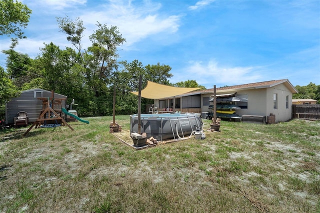 565 S Floyd Cir, Deltona, FL 32725 - view of grassy yard with a playground and an outdoor pool