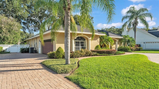 1455 Royal Forest Loop, Lakeland, FL 33811 - view of front of property with decorative driveway, stucco siding, and a garage