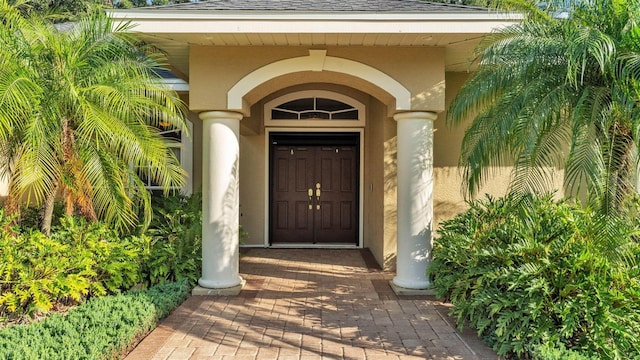 1455 Royal Forest Loop, Lakeland, FL 33811 - entrance to property featuring a shingled roof and stucco siding