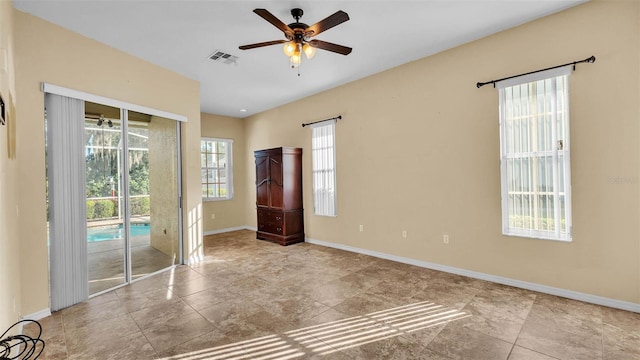 1455 Royal Forest Loop, Lakeland, FL 33811 - unfurnished room with ceiling fan and stone finish flooring