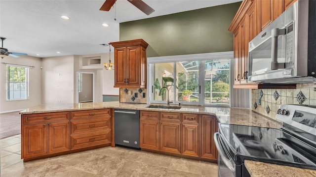 1455 Royal Forest Loop, Lakeland, FL 33811 - kitchen featuring appliances with stainless steel finishes, a ceiling fan, brown cabinetry, and recessed lighting