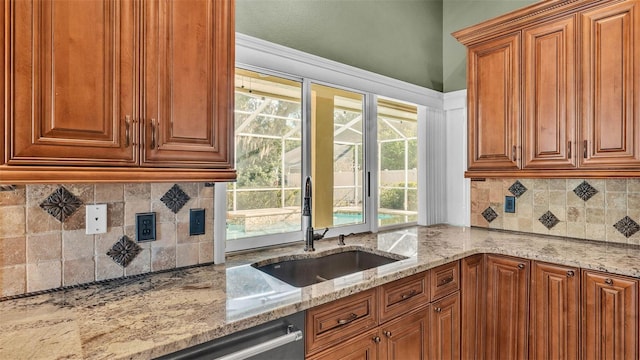 1455 Royal Forest Loop, Lakeland, FL 33811 - kitchen with light stone counters, brown cabinets, and backsplash