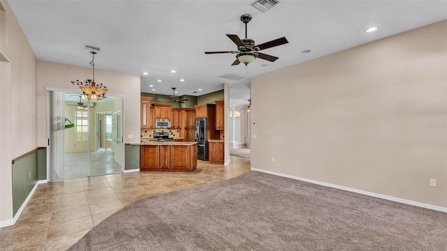 1455 Royal Forest Loop, Lakeland, FL 33811 - kitchen featuring appliances with stainless steel finishes, open floor plan, light countertops, brown cabinets, and a ceiling fan