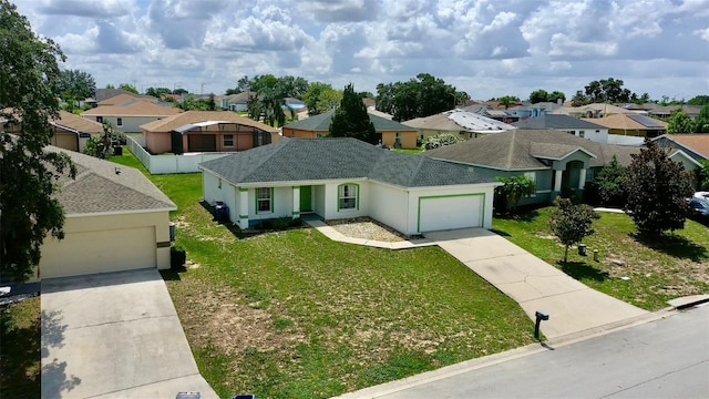 130 Winsor Ave, Davenport, FL 33837 - single story home with concrete driveway, an attached garage, a residential view, and a front lawn