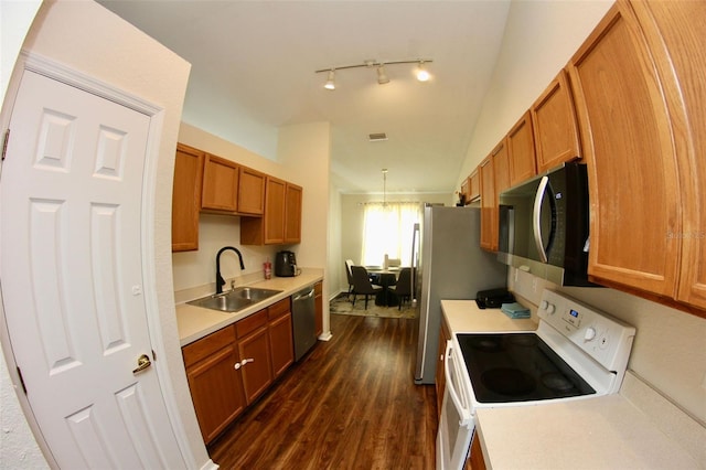 130 Winsor Ave, Davenport, FL 33837 - kitchen featuring stainless steel appliances, dark wood-style floors, light countertops, brown cabinets, and lofted ceiling