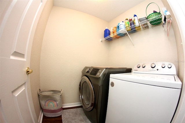 130 Winsor Ave, Davenport, FL 33837 - laundry area featuring washer and clothes dryer and wood finished floors