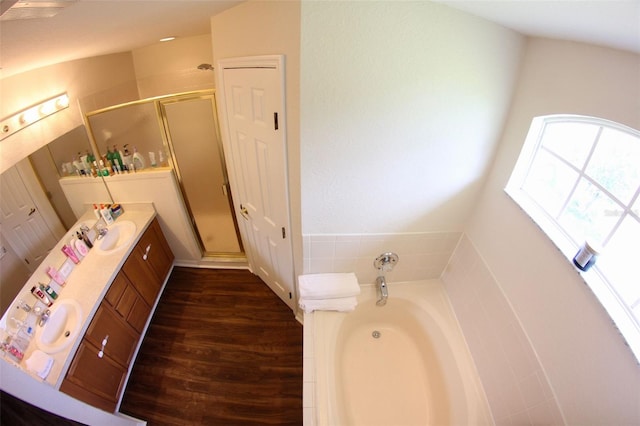 130 Winsor Ave, Davenport, FL 33837 - bathroom featuring vanity, a stall shower, a bath, and wood finished floors