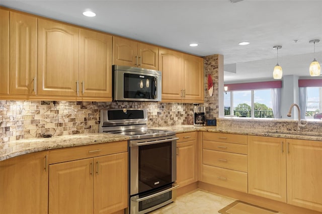 4 Oceans W Blvd Unit 502D, Daytona Beach Shores, FL 32118 - kitchen with stainless steel appliances, light brown cabinets, light stone countertops, backsplash, and recessed lighting