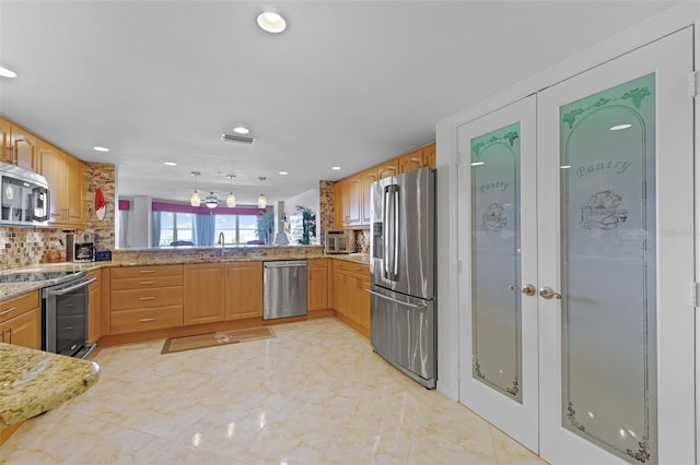 4 Oceans W Blvd Unit 502D, Daytona Beach Shores, FL 32118 - kitchen with appliances with stainless steel finishes, decorative backsplash, recessed lighting, light stone counters, and light marble finish flooring