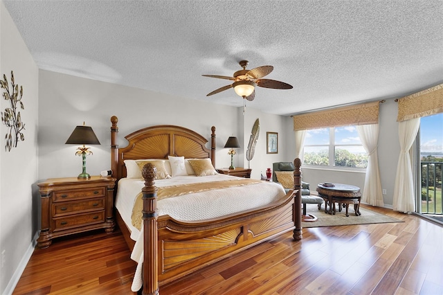 4 Oceans W Blvd Unit 502D, Daytona Beach Shores, FL 32118 - bedroom with multiple windows, a textured ceiling, access to outside, wood finished floors, and ceiling fan