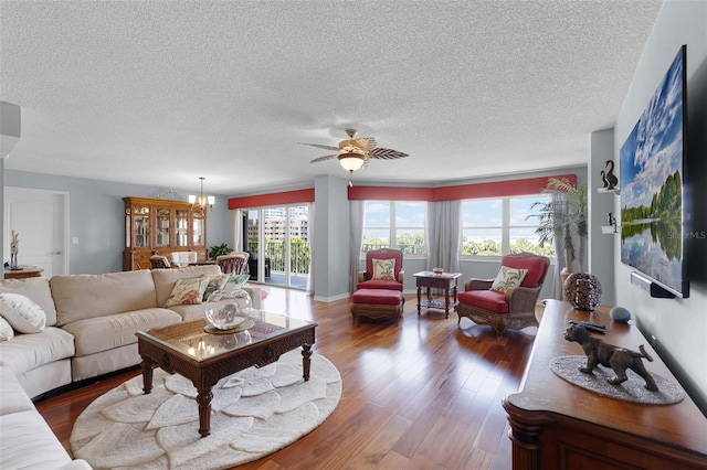 4 Oceans W Blvd Unit 502D, Daytona Beach Shores, FL 32118 - living room with a textured ceiling, ceiling fan, wood finished floors, and a chandelier