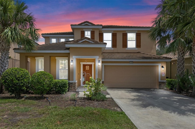 5172 Oakbourne Ave, Davenport, FL 33837 - view of front of property with stucco siding, a garage, driveway, and a tile roof