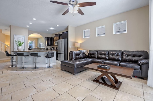 5172 Oakbourne Ave, Davenport, FL 33837 - living area featuring a ceiling fan, arched walkways, light tile patterned flooring, recessed lighting, and stairs