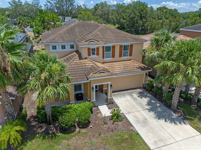 5172 Oakbourne Ave, Davenport, FL 33837 - view of front of house featuring a tiled roof, stucco siding, concrete driveway, and an attached garage