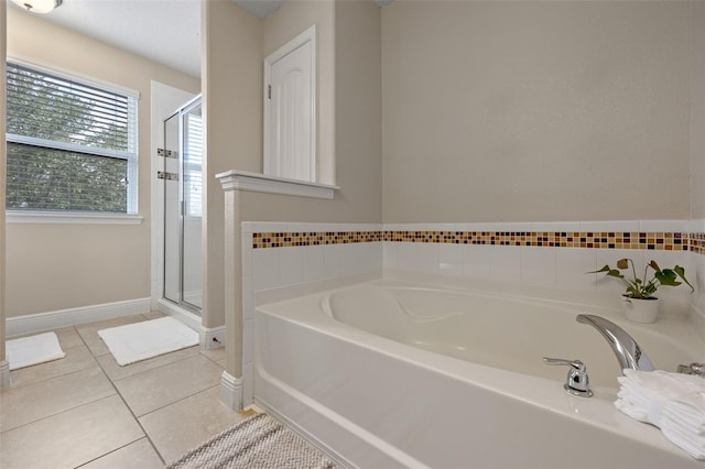5172 Oakbourne Ave, Davenport, FL 33837 - full bathroom featuring a garden tub, a shower stall, and tile patterned floors