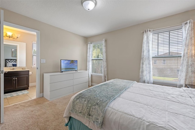 5172 Oakbourne Ave, Davenport, FL 33837 - carpeted bedroom featuring ensuite bathroom and baseboards