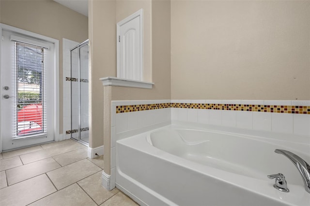 5172 Oakbourne Ave, Davenport, FL 33837 - bathroom featuring a garden tub, a shower stall, and tile patterned floors