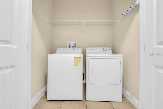 5172 Oakbourne Ave, Davenport, FL 33837 - laundry area featuring washing machine and clothes dryer and light tile patterned floors
