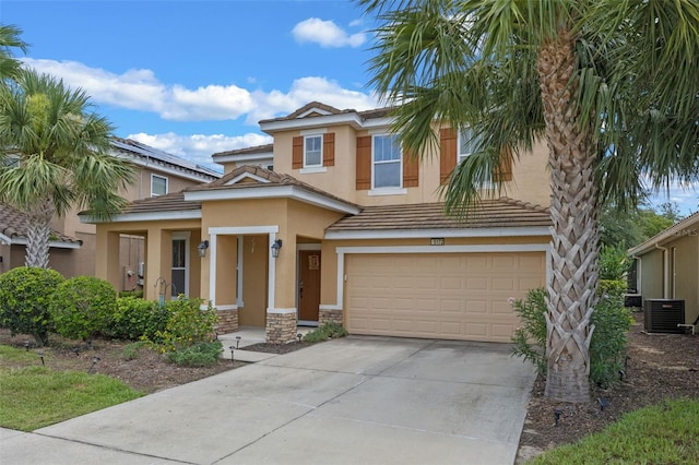 5172 Oakbourne Ave, Davenport, FL 33837 - view of front facade featuring stucco siding, an attached garage, stone siding, driveway, and a tiled roof