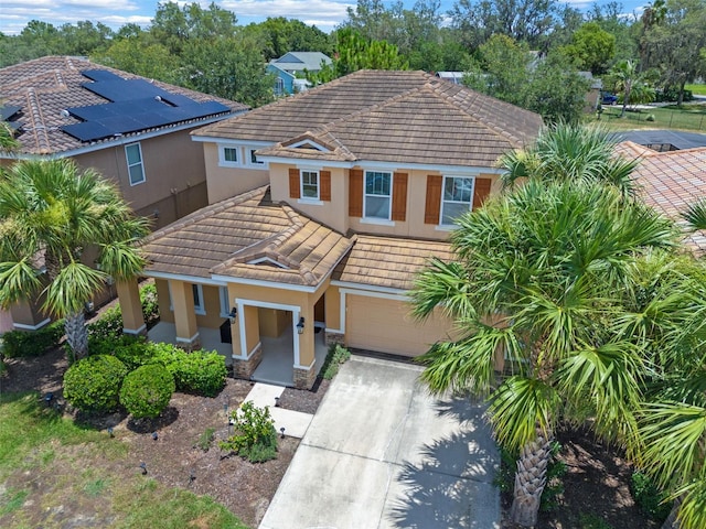 5172 Oakbourne Ave, Davenport, FL 33837 - view of front of home featuring a tiled roof, stucco siding, a garage, and driveway