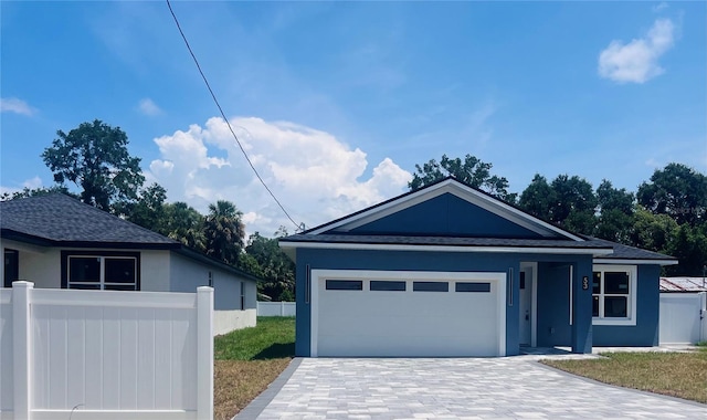 63 W 10th St, Apopka, FL 32703 - ranch-style home featuring stucco siding, a garage, decorative driveway, and a shingled roof