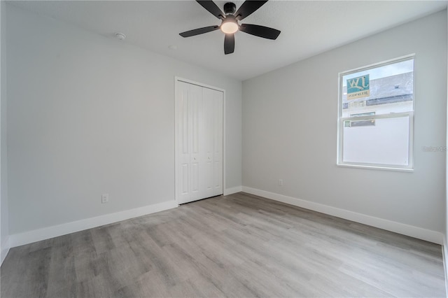 63 W 10th St, Apopka, FL 32703 - unfurnished bedroom with light wood-style flooring, a closet, and a ceiling fan