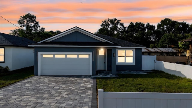 63 W 10th St, Apopka, FL 32703 - single story home featuring a garage, decorative driveway, and stucco siding