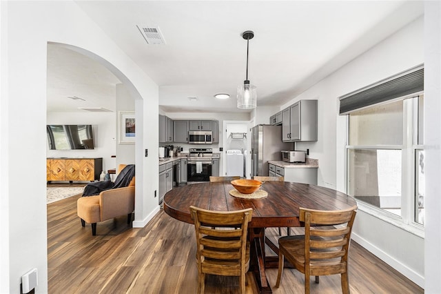 5430 NW 55th Pl, Ocala, FL 34482 - dining room with dark wood-type flooring, arched walkways, and healthy amount of natural light