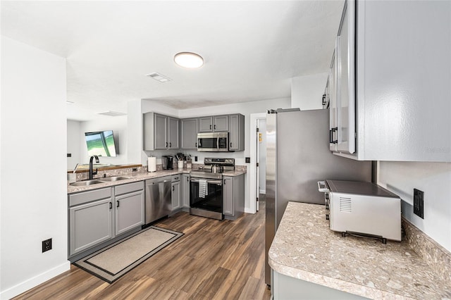 5430 NW 55th Pl, Ocala, FL 34482 - kitchen featuring gray cabinets, appliances with stainless steel finishes, dark wood-type flooring, and light countertops