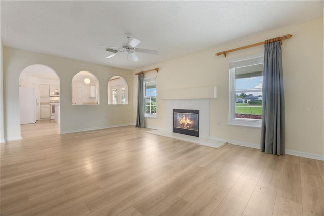 16243 Wilkinson Dr, Clermont, FL 34714 - unfurnished living room featuring light wood-style flooring, plenty of natural light, and a ceiling fan