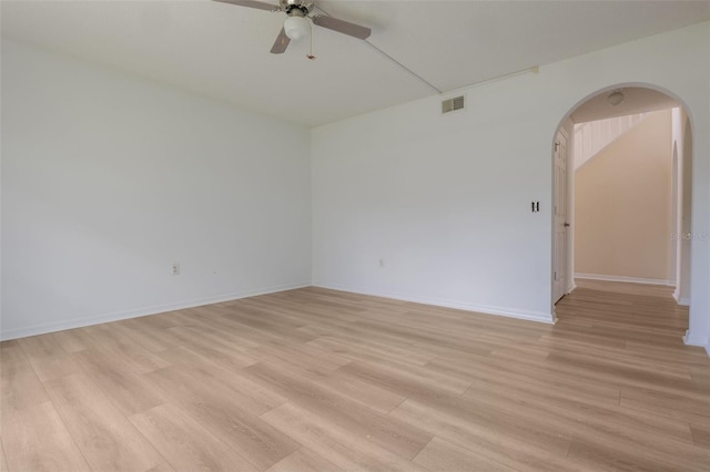 16243 Wilkinson Dr, Clermont, FL 34714 - unfurnished room featuring arched walkways, a ceiling fan, and light wood finished floors