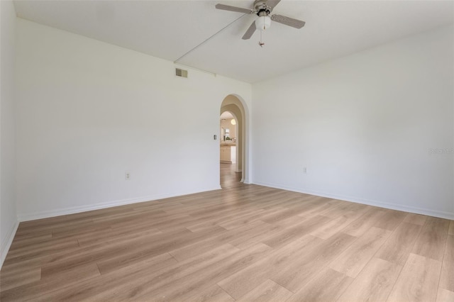 16243 Wilkinson Dr, Clermont, FL 34714 - spare room featuring a ceiling fan, arched walkways, and light wood-style flooring