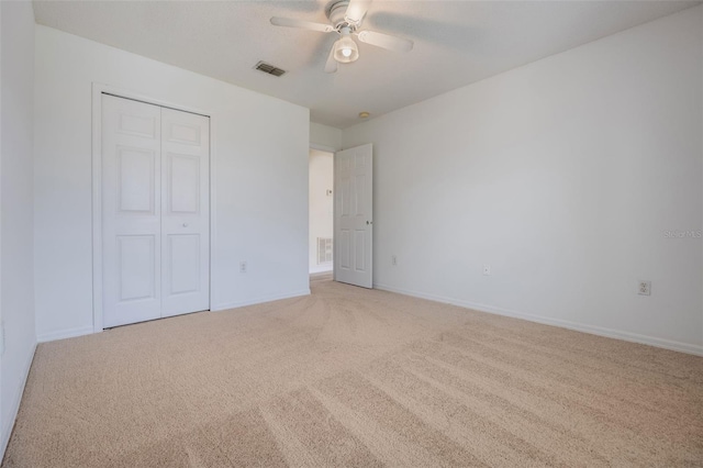 16243 Wilkinson Dr, Clermont, FL 34714 - unfurnished bedroom with light carpet, a closet, and a ceiling fan