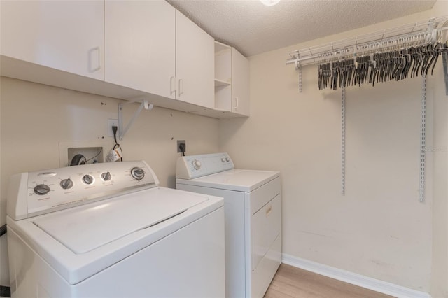 16243 Wilkinson Dr, Clermont, FL 34714 - laundry room featuring cabinet space, washing machine and dryer, light wood-type flooring, and a textured ceiling