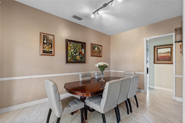 1225 Hollow Pine Dr, Oviedo, FL 32765 - dining room with a textured ceiling and track lighting