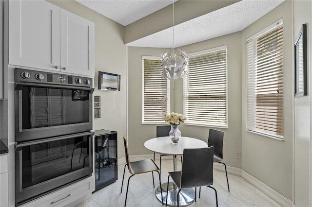 1225 Hollow Pine Dr, Oviedo, FL 32765 - dining area with a chandelier and a textured ceiling