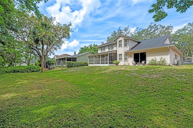 1225 Hollow Pine Dr, Oviedo, FL 32765 - back of property with a sunroom, stucco siding, and a lawn